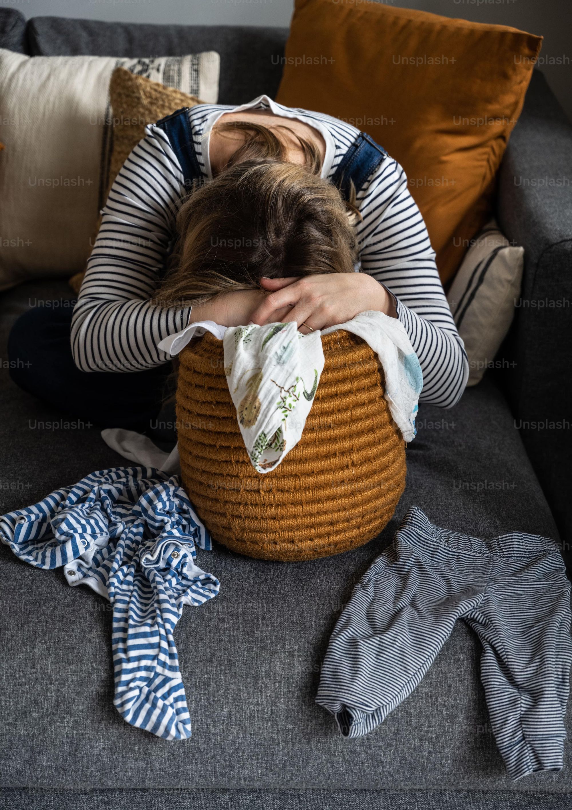 Tired Woman sleeping on laundry basket